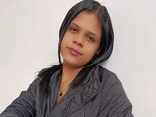 valentinabelle has short black hair and a neutral expression, wearing a black quilted jacket against a plain white background.
