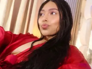 yourcuteneighbourr poses with a pouting lip, wearing a red silk robe with her long dark hair falling over her shoulders.
