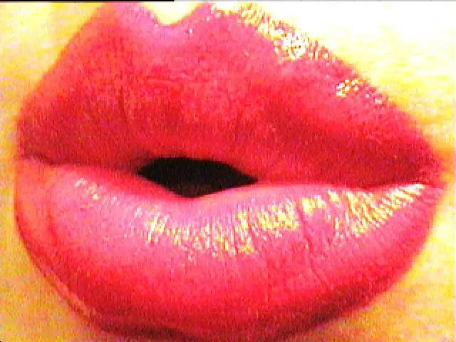 CurvyKatty40DD — Close-up of glossy bright pink lips with a shimmering texture for a bold makeup look.