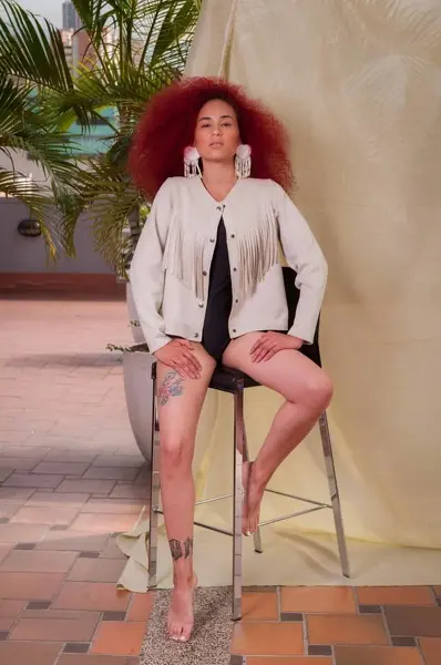 Kim_Stonne has wet, curly hair and a wet face, looking directly at the camera with a direct gaze.